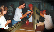 Riveting the nose skin to the rudder assembly.