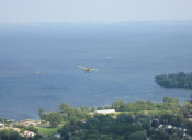The STOL CH 750 turns on the base leg over Lake Winnebago to land on Runway 27