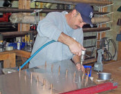 Mr. Henry drills the rear skin of the rudder assembly